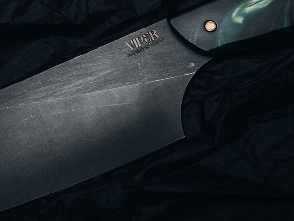Hand-forged kitchen knife edge close up, showing the fine bevel that decides edge retention