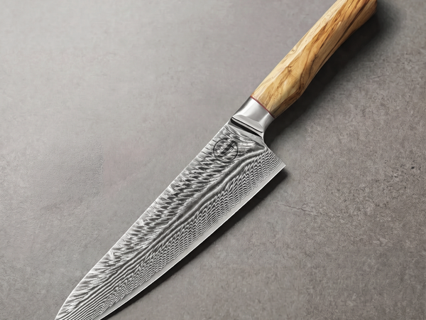 Feather Forge 8 inch chef knife in 73-layer Damascus over an AUS-10 high carbon core, the clad construction SG2 blades also use