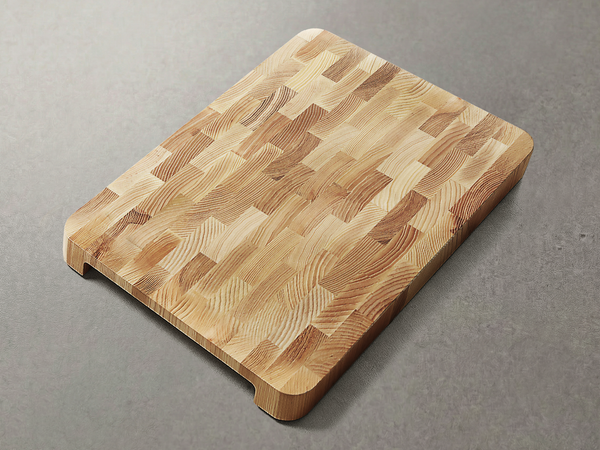 End grain ash wood cutting board on a kitchen counter, clean and dry