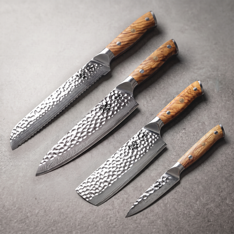 Silver Dynasty Emperor Set: 8 inch bread, 8 inch chef, 7 inch nakiri and 4 inch paring knives laid on slate