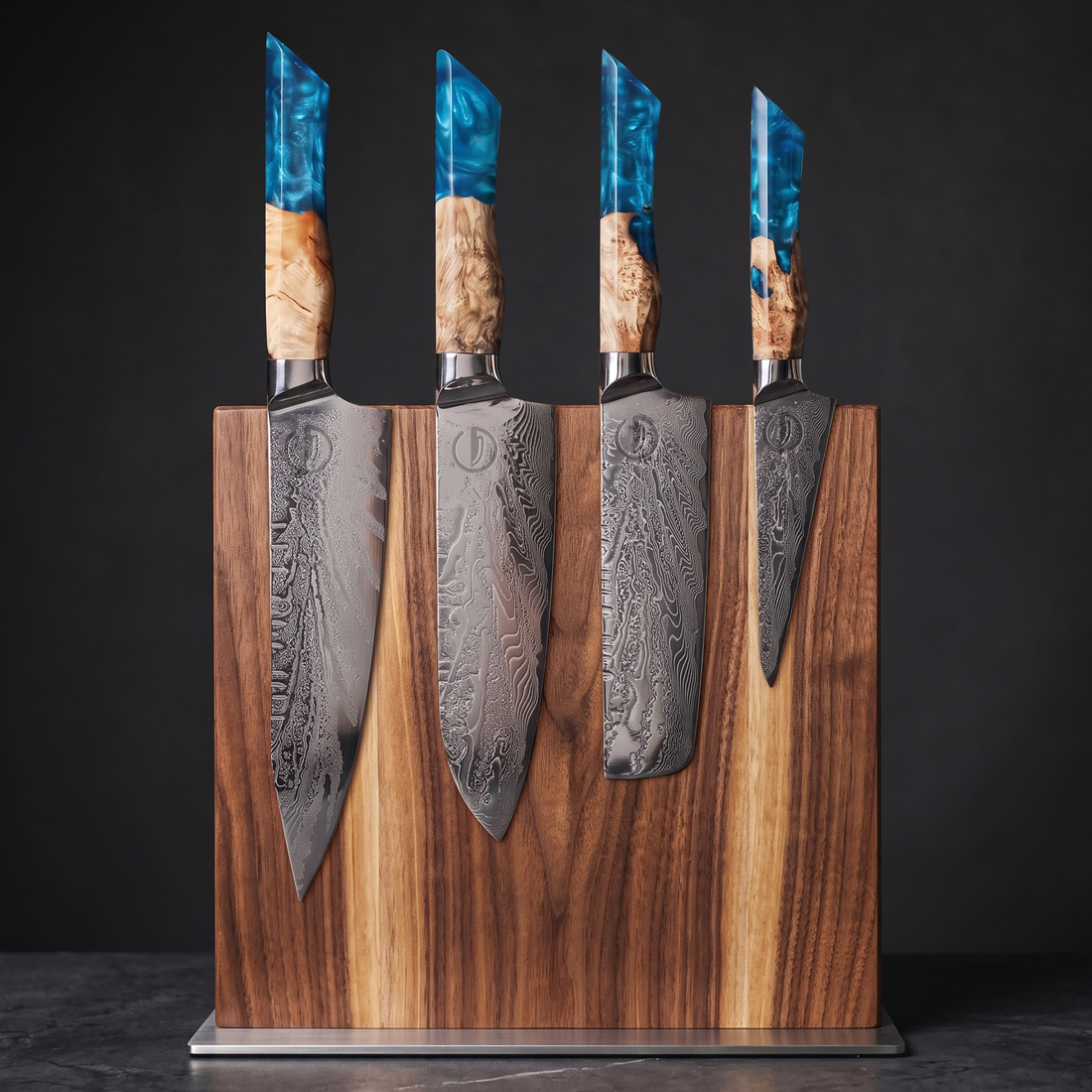 Feather Forge Sapphire Emperor's Throne Set: chef, santoku, nakiri and utility knives with sapphire blue epoxy handles on the acacia magnetic display block