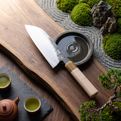 Torii 7-inch santoku knife resting on a wooden cutting board