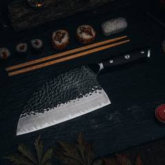 Serbian cleaver slicing prepared fish on a wooden board
